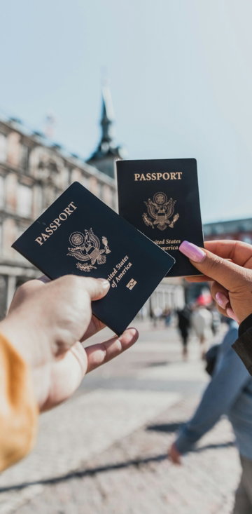 person-holding-passports.jpg person holding passports