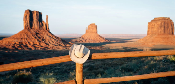 cowboy-hat-on-wooden-fence-with-monument-valley-in-background-.jpg Cowboy hat on wooden fence with monument valley in background.